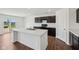 Bright kitchen featuring a center island, stainless steel sink and laminate wood floor at 1304 Vera Blvd, Danville, IN 46122