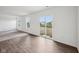 Bright and airy living room with laminate floors, large windows, and access to the outdoors at 1304 Vera Blvd, Danville, IN 46122