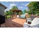 Back deck with gazebo, various chairs, and blue umbrella and cushions at 13910 Brightwater Dr, Fishers, IN 46038