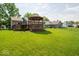 Spacious backyard with a deck and gazebo, surrounded by lush green lawns at 13910 Brightwater Dr, Fishers, IN 46038