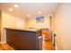 Basement bar area with ample counter space, wooden cabinets, and a charming beach-themed painting at 13910 Brightwater Dr, Fishers, IN 46038