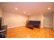 Finished basement area with hardwood floors, recessed lighting, and a comfortable futon couch at 13910 Brightwater Dr, Fishers, IN 46038