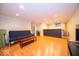 Finished basement area with hardwood floors, recessed lighting, and a comfortable futon couch at 13910 Brightwater Dr, Fishers, IN 46038