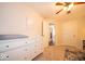 Neutral bedroom featuring a ceiling fan, dresser, and doorway to another room at 13910 Brightwater Dr, Fishers, IN 46038