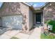 Charming single-story brick home featuring an attached two-car garage and front door access at 13910 Brightwater Dr, Fishers, IN 46038