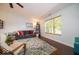 Comfortable living room with a large window, ceiling fan, and inviting seating area at 13910 Brightwater Dr, Fishers, IN 46038