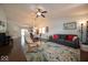 Bright living area featuring hardwood floors, ceiling fan, and an open-concept design at 13910 Brightwater Dr, Fishers, IN 46038