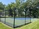 Community tennis court featuring a well-maintained playing surface and surrounding fence at 13910 Brightwater Dr, Fishers, IN 46038