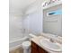 Standard bathroom with tile flooring featuring a shower and tub, a vanity, and a mirrored wall at 1525 Bluestem Dr, Greenwood, IN 46143