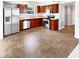 Functional kitchen features cherry cabinets, stainless steel appliances, tile flooring, and a practical layout at 1525 Bluestem Dr, Greenwood, IN 46143