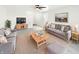 Cozy living room boasts neutral walls, plush sofas, ceiling fan, area rug, and stylish furnishings for comfortable living at 1525 Bluestem Dr, Greenwood, IN 46143