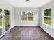 Bright sun room with updated tile flooring and slider door to the backyard at 1525 Bluestem Dr, Greenwood, IN 46143