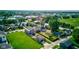 A high-angle shot captures the neighborhood's homes amidst lush greenery and mature trees at 1622 Cornell Ave, Indianapolis, IN 46202