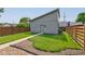 Backyard featuring a well-maintained lawn, gravel landscaping, a privacy fence, and access to the detached garage at 1622 Cornell Ave, Indianapolis, IN 46202