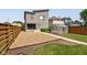Spacious backyard featuring a greenhouse, gravel area, and a wooden fence, creating a private and serene outdoor space at 1622 Cornell Ave, Indianapolis, IN 46202