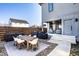 Backyard patio featuring an outdoor dining table, chairs, grills, and access to a covered fireplace area at 1622 Cornell Ave, Indianapolis, IN 46202