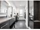 Modern bathroom with dual vanities, sleek gray tile, and glass-enclosed shower at 1622 Cornell Ave, Indianapolis, IN 46202
