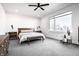 Spacious bedroom with a large window, ceiling fan, and stylish decor at 1622 Cornell Ave, Indianapolis, IN 46202