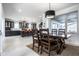 An open-concept dining room showcases wood table and seating bathed in natural light from a large window at 1622 Cornell Ave, Indianapolis, IN 46202