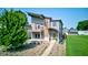Modern home with a green door, a balcony, a manicured lawn, and attractive landscaping, showcasing contemporary design at 1622 Cornell Ave, Indianapolis, IN 46202