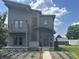 Stylish two-story home with neutral siding, a balcony, green front door, and carefully designed front yard landscaping at 1622 Cornell Ave, Indianapolis, IN 46202