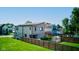 Modern home with a greenhouse, wooden fence, and well-manicured lawn at 1622 Cornell Ave, Indianapolis, IN 46202