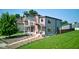 Modern home featuring unique architecture, a small balcony, a green front lawn, and tasteful landscaping at 1622 Cornell Ave, Indianapolis, IN 46202