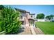 A modern two-story home with a green door, stylish stonework, and well-manicured landscaping at 1622 Cornell Ave, Indianapolis, IN 46202