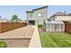 Modern home with a greenhouse, gravel landscaping, privacy fence, and walkway leading to the front porch at 1622 Cornell Ave, Indianapolis, IN 46202