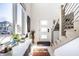 Bright, modern foyer featuring a staircase with metal railings, large window, and contemporary decor at 1622 Cornell Ave, Indianapolis, IN 46202