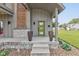Inviting front porch with a stylish green door, stone accents, and elegant planters for added curb appeal at 1622 Cornell Ave, Indianapolis, IN 46202