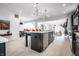 Open kitchen with a large island, stainless appliances, and views into the dining and living areas at 1622 Cornell Ave, Indianapolis, IN 46202