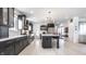 Modern kitchen with dark cabinets, stainless steel appliances, an island with seating, and bright, open layout at 1622 Cornell Ave, Indianapolis, IN 46202