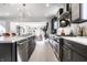 Bright, open kitchen boasts stainless steel appliances, an island with seating, and a seamless flow to living spaces at 1622 Cornell Ave, Indianapolis, IN 46202