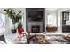 Open-concept living room featuring a modern fireplace, contemporary decor, and seamless flow into the kitchen area at 1622 Cornell Ave, Indianapolis, IN 46202