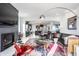 A stylish living room features a fireplace, modern lighting, and an open layout connected to the kitchen at 1622 Cornell Ave, Indianapolis, IN 46202