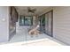 Covered outdoor patio with stone fireplace, ceiling fan, and sliding glass doors, perfect for relaxation and entertainment at 1622 Cornell Ave, Indianapolis, IN 46202