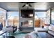 Relaxing outdoor patio featuring a cozy fireplace, comfortable seating, and mounted television at 1622 Cornell Ave, Indianapolis, IN 46202