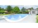 Large pool with diving board, concrete pool surround, and mature landscaping offers a resort-like experience at 164 Wellington Pkwy, Noblesville, IN 46060