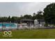 Community pool surrounded by lounge chairs and umbrellas, a perfect spot for relaxation and recreation at 164 Wellington Pkwy, Noblesville, IN 46060