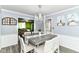 Comfortable dining area with views into the living room, featuring a decorative chandelier at 164 Wellington Pkwy, Noblesville, IN 46060