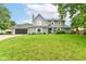 Charming two-story home featuring a well-manicured lawn, attached garage, and inviting front entrance at 164 Wellington Pkwy, Noblesville, IN 46060