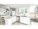Bright kitchen with granite counters, stainless appliances, and stylish white cabinetry at 164 Wellington Pkwy, Noblesville, IN 46060