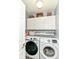 Functional laundry room featuring white cabinets and modern washer and dryer units at 164 Wellington Pkwy, Noblesville, IN 46060