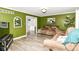 Spacious living room boasts green walls and open doorway to dining area at 164 Wellington Pkwy, Noblesville, IN 46060