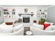 Bright living room with fireplace, built-in shelving, hardwood flooring and comfortable oversized seating at 164 Wellington Pkwy, Noblesville, IN 46060