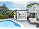 Poolside view of a patio with a pool house, grill and patio furniture, perfect for outdoor gatherings at 164 Wellington Pkwy, Noblesville, IN 46060