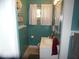 Cozy bathroom featuring turquoise walls, white vanity, and window with natural light at 213 S Coventry Dr, Anderson, IN 46012