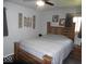 Bedroom with a wooden bed frame, ceiling fan, and decor above the headboard at 213 S Coventry Dr, Anderson, IN 46012