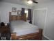 Bedroom featuring a wooden bed frame, side tables, and decor with neutral walls at 213 S Coventry Dr, Anderson, IN 46012